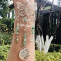 Detail of silver suncatcher with butterfly, moon, star charms and green stone beads - Green Strawberry Quartz