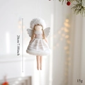 Detail of a 20cm white plush angel ornament with glitter wings for Christmas decor - White