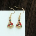 Close-up of Christmas tree earrings with colorful rhinestones and white pearls - Pearl and Rhinestone Tree