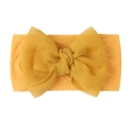 Detail shot of a yellow double-layered knotted bow on a soft nylon baby turban headband - Khaki/Earth Yellow