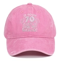 Detailed embroidery on a pink washed cotton 70th birthday baseball hat in white text - 70th Birthday / Pink