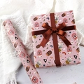 Pink cartoon insect gift wrapping paper roll and gift box with dark brown satin bow - Ladybug