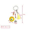 Macro detail of evil eye keychain with measurements, yellow tassels and glass beads - Yellow Disc Small Eye Tassel