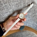 Close-up of white leather quartz watch with rose gold case and checkered dial - White Strap