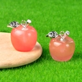 Pink crystal mini apple pendant with silver leaf detail on a wooden spoon display - Watermelon Red (Synthetic)