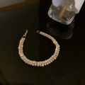 Macro shot of gold zircon bracelet with rectangular crystals and sparkling starburst effects - Gold Rectangular (Style 1)