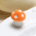 Macro shot of an orange ceramic mushroom with white spots for DIY micro landscape decor - Orange