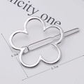 Macro view of silver floral contour hair clip with size dimensions 5.7cm by 4.3cm - Silver Flower Shape