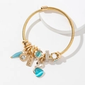 Pulsera de cable dorado con elegante colgante de cisne y dijes de piedra ojo de gato - Azul
