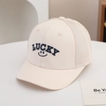 Detail of LUCKY letter embroidery and breathable mesh on a beige kids' trucker cap - 54cm (3-8 Years) / LUCKY-Rice White