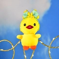 Detailed view of a cute yellow duck plush pendant wearing a mint green bow headband. - Green Headband Style (Duck) / 12cm