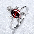 Silver turtle ring featuring a large oval red crystal and sparkling white stones - Red Zircon