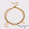 Detailed view of golden double-layer chain bracelet with star and moon mother-of-pearl charms - 18CM+4CM / Bracelet
