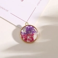 Alloy circle pendant featuring natural purple and magenta dried flowers in gold frame - Style 14