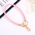 Pink 6mm braided leather keychain wrist strap with gold hardware on white surface - Pink