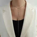Minimalist silver Y-shaped long tassel necklace in titanium steel worn by model - Long / Steel