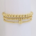 Three-layer golden beaded bracelet set featuring a round charm with letter F engraving - Letter F