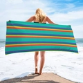 Detailed view of oversized colorful striped beach towel held on a sunny coast - Colorful Horizontal Stripes