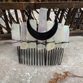 Detail of handcrafted black metal hair comb featuring iridescent crystals and moon charm - Aura Clear Quartz Black Moon