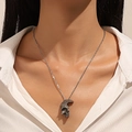 Macro shot of a vintage silver skull pendant necklace worn on a white shirt - Vintage Silver Skull Pendant Necklace (30) / Antique Silver