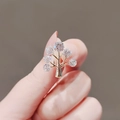 Close-up of a small golden tree brooch with shimmering round clear crystals - Gold Zirconia Tree