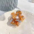 Elegant floral acetate hair claw with orange blue spots and a pearl center on ceramic tray - 5.3cm / Orange Blue Spotted