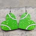 Close-up of heart-shaped tennis pattern faux leather earrings on concrete background - Tennis Ball