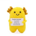 Handmade crochet positive axolotl doll in yellow yarn holding a motivational card - Standing Axolotl Goose Yellow Body Gold P Card