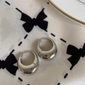 Detailed close-up of polished silver C-shaped hoop earrings on elegant silk fabric - Silver Ear Buckle (15#)