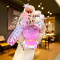 Detail of pink liquid glitter keychain featuring Mickey-shaped bubble and floating charms - Pink Sitting Bear with Gradient Rope