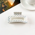 Close-up of white square hair claw clip with holographic skull pattern on a clean background - 8.5cm Square - Creamy White Holographic Skull