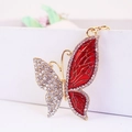Detail of a golden butterfly keychain with clear rhinestones and red enamel finish - Individual Packaging / Red
