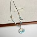 Macro shot of seashell pendant and blue star details on a layered beaded necklace - Blue Shell Necklace H-80