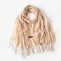 Soft beige cashmere scarf with elegant tassels and woven texture in a flat lay view - Beige