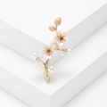 Spilla ramo di pruno con petali bianchi, gemme rosse e perle su sfondo bianco minimalista - Oro