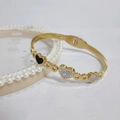 Detail of gold watchband bracelet featuring heart charms with enamel and mother of pearl - 363 Gold Bangle (363 Gold)