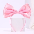 Pink satin bow headband for girls with a large double-layer glossy ribbon on a white stand - Pink