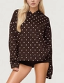 Detailed close-up of dark brown polka dot hoodie featuring a functional kangaroo pocket - S / Coffee