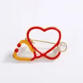 Creative medical stethoscope heart brooch in vibrant red and orange enamel finish - Heart Stethoscope