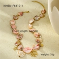 Detail of pink shell beach necklace with golden starfish and coral textured pendants - Pink Coral Necklace