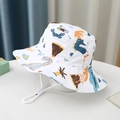 Close-up of children's white bucket hat with colorful dinosaur prints and adjustable chin strap - Size 52 Approx. 2-5 Years / White Forest Dinosaur