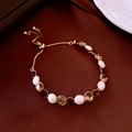 Detail of adjustable gold-plated bracelet with crystals and red gemstone on leather - Orange Red