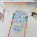 Dettaglio della trapuntatura a cuore e etichetta sulla borsa per fotocamera a scacchi - Cuore blu a quadretti trapuntato