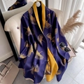 Detail of reversible cashmere scarf with gold ginkgo leaves and soft fringe edges - Blue