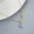 Detail shot of heart-shaped blue stone and crystal-encrusted pin pendant necklace - Gold Blue