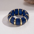 Detail of blue glitter acrylic segments and gold metal beads on elastic bracelet - Blue