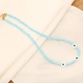 Handmade necklace with light blue beads, evil eye charms and gold clasp on white fabric - Light Blue Eye Style (1#)