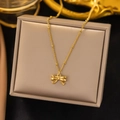 Elegant 18K gold-plated bow pendant necklace with beaded chain on jewelry box - Gold-Bowknot
