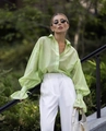 Detail of light green sheer chiffon blouse with flared cuffs and white high-waist trousers - S / Matcha Green