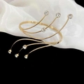 Detailed macro of a gold-plated spiral arm cuff featuring sparkling diamond-cut rhinestones - Gold Spiral Rhinestone Bangle (HB2607)